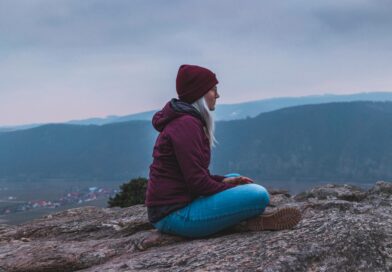 A female traveler chilling at a mountain top.