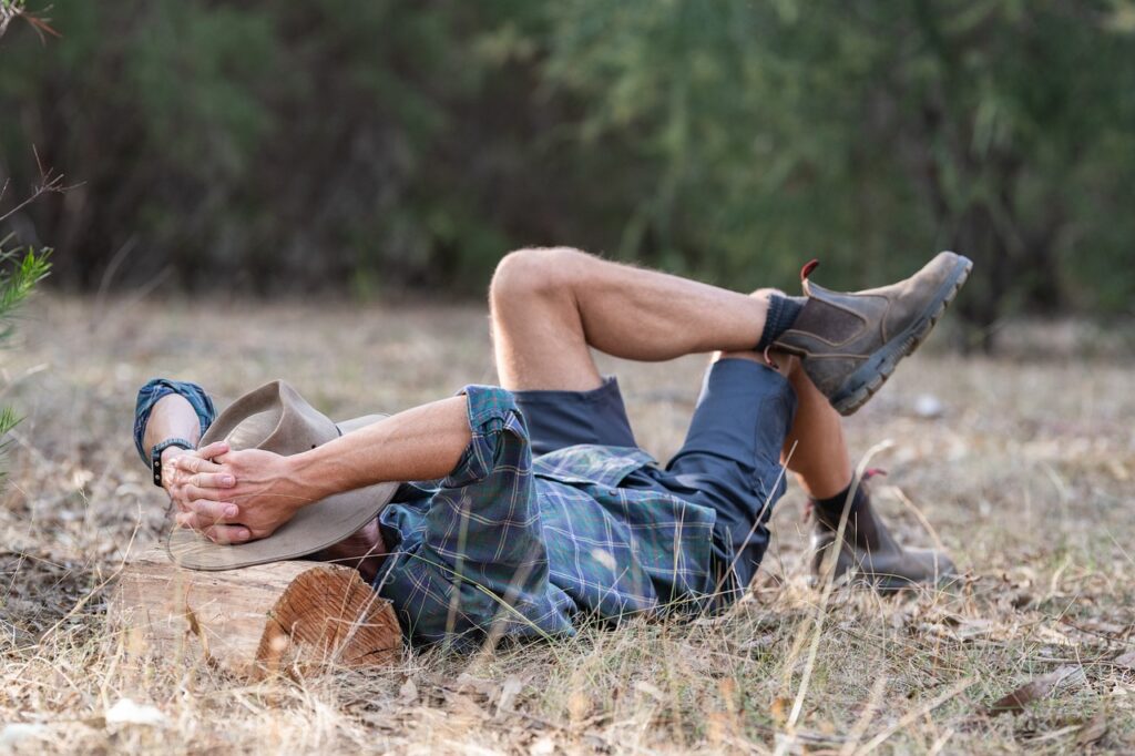 Man relaxing on the ground in a forest