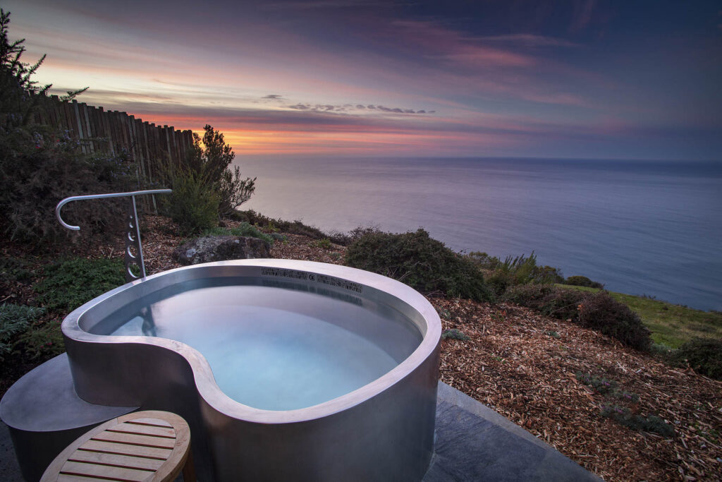 A bathtub overlooking the ocean. 