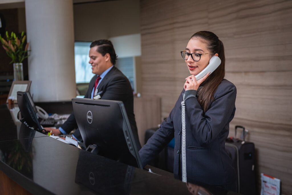 Female hotel receptionist on the phone