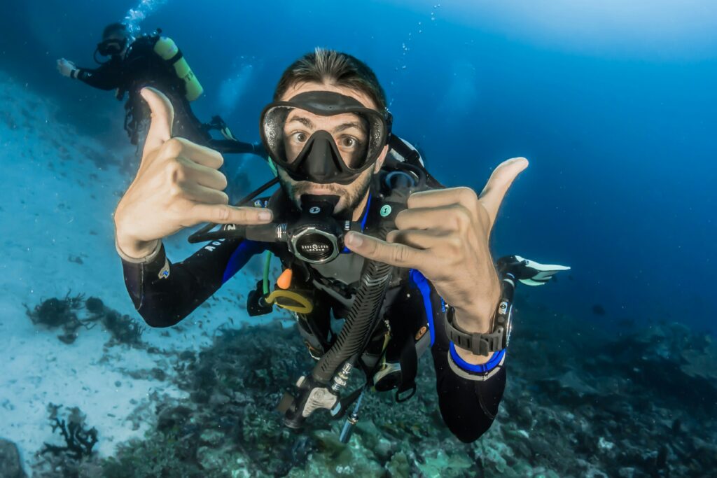 A diving throwing hand signs to the camera