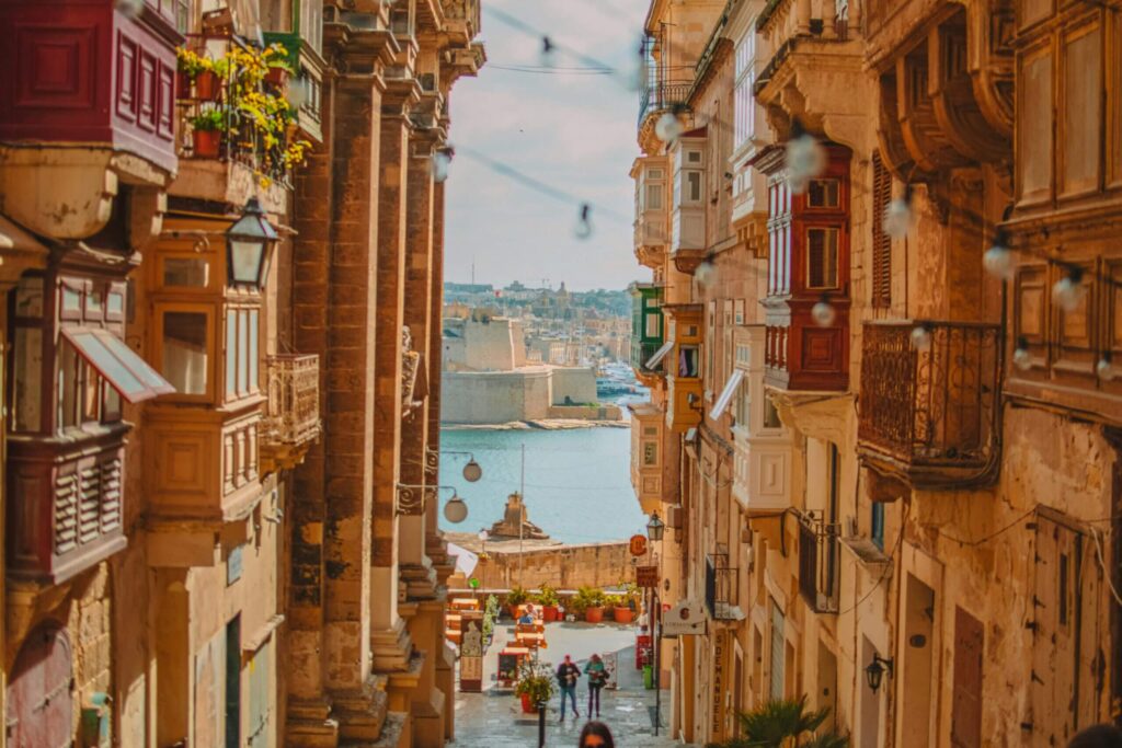 The city of Valletta. Between two buildings eyeing the harbour in the background. 