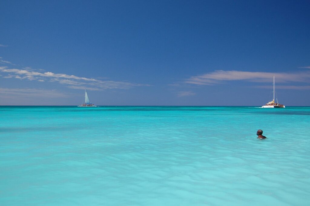A man swimming in the blue waters of the Dominican Republic