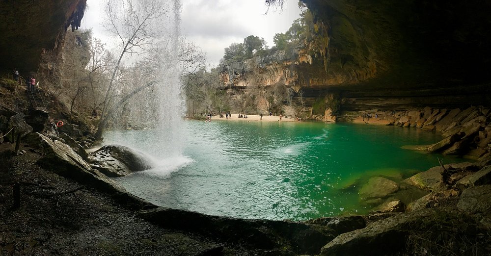 Emerald swimming hole under limestone overhang at Hamilton Pool Preserve, Texas hidden gem