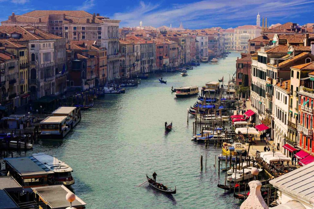 Gondolas and water buses on the Grand Canal in Venice, with palaces along the water