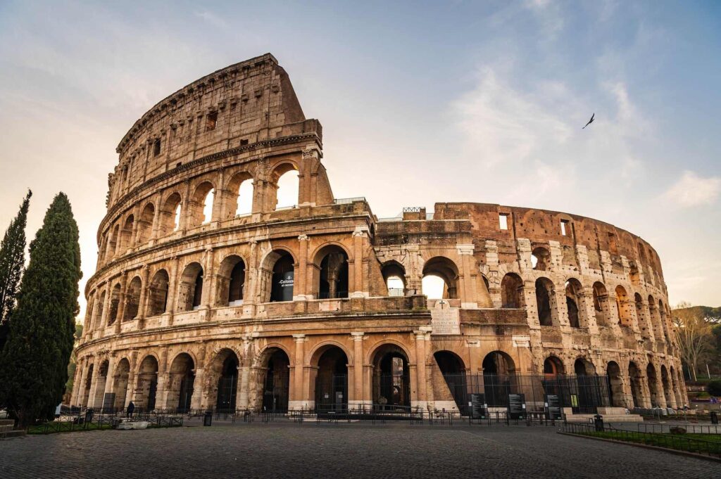 The Colosseum in Rome at golden hour, a highlight of any first trip to Italy