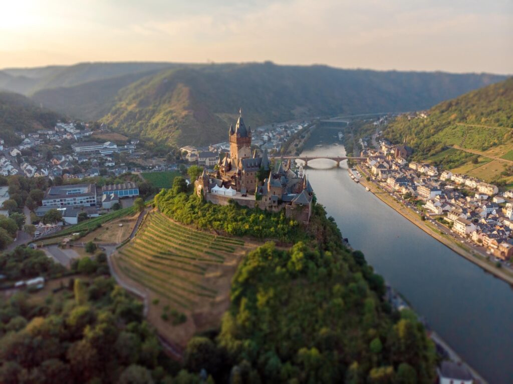 Reichsburg Cochem castle above the Moselle River and vineyards